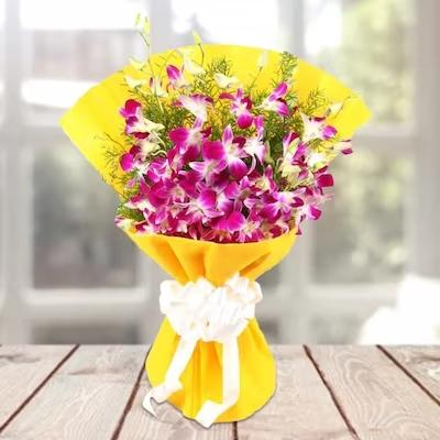 Orchids Beauty In Yellow Bright Wrapping Flower Type: Purple Orchids , No. of Stems: 8 , Fillers: Green Seasonal Fillers.

